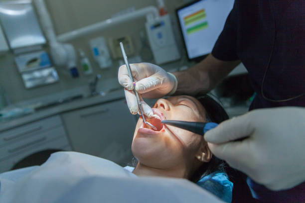 Female patient having teeth implant operation